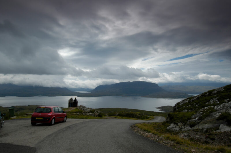 A Car Travels Along The A896 Through The Beinn Eighe Nature Reserve