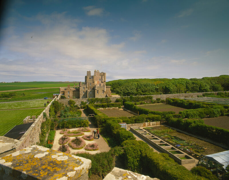 Looking Down To A Couple Examining A Neatly Tende  Flower Border In The Gardens Of The Castle Of Mey