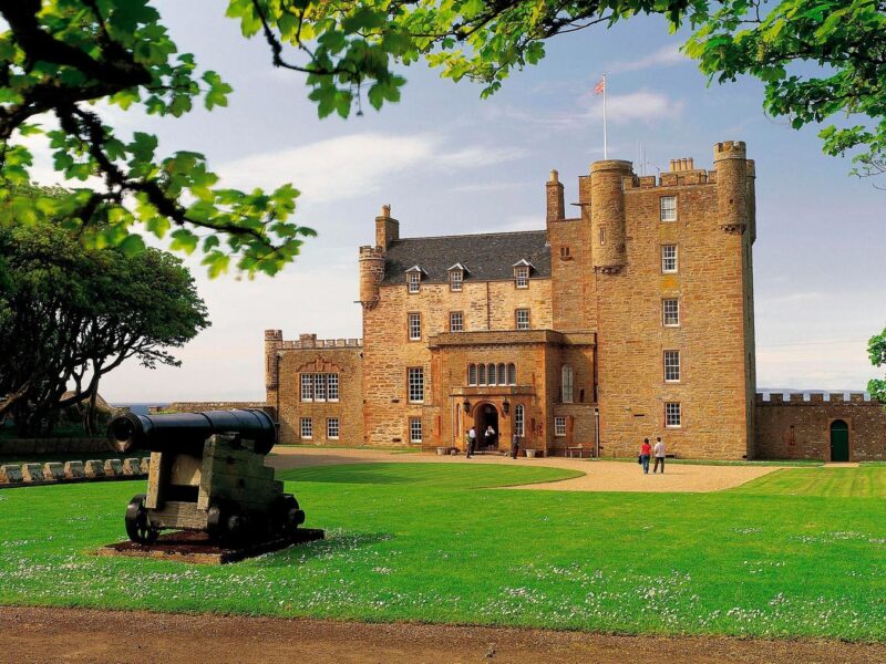 Looking Over An Ornamental Cannon To The Castle Of Mey View 1